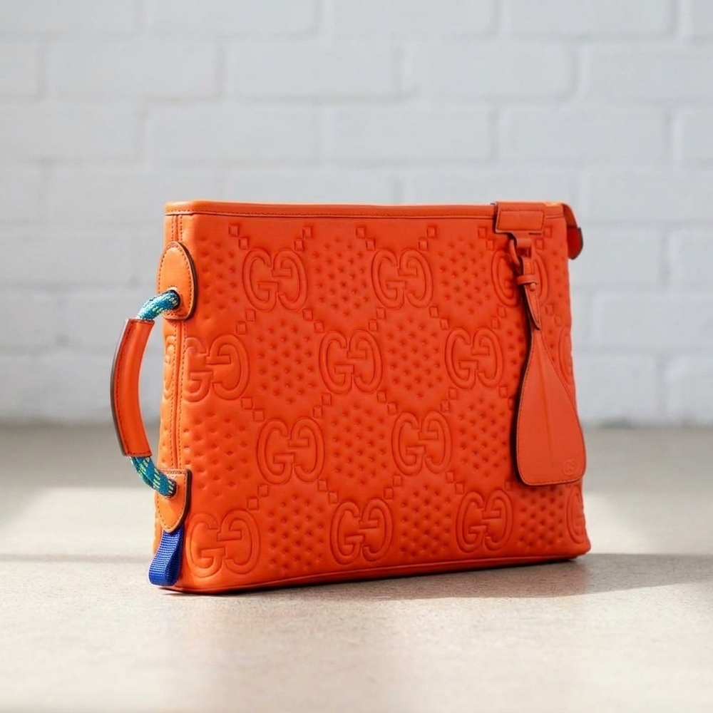 NEW GUCCI women's off the grid gg embossed rubber pouch clutch bag in orange